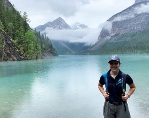 Youth employment program intern standing in front of Kinney Lake at Mount Robson Provincial Park