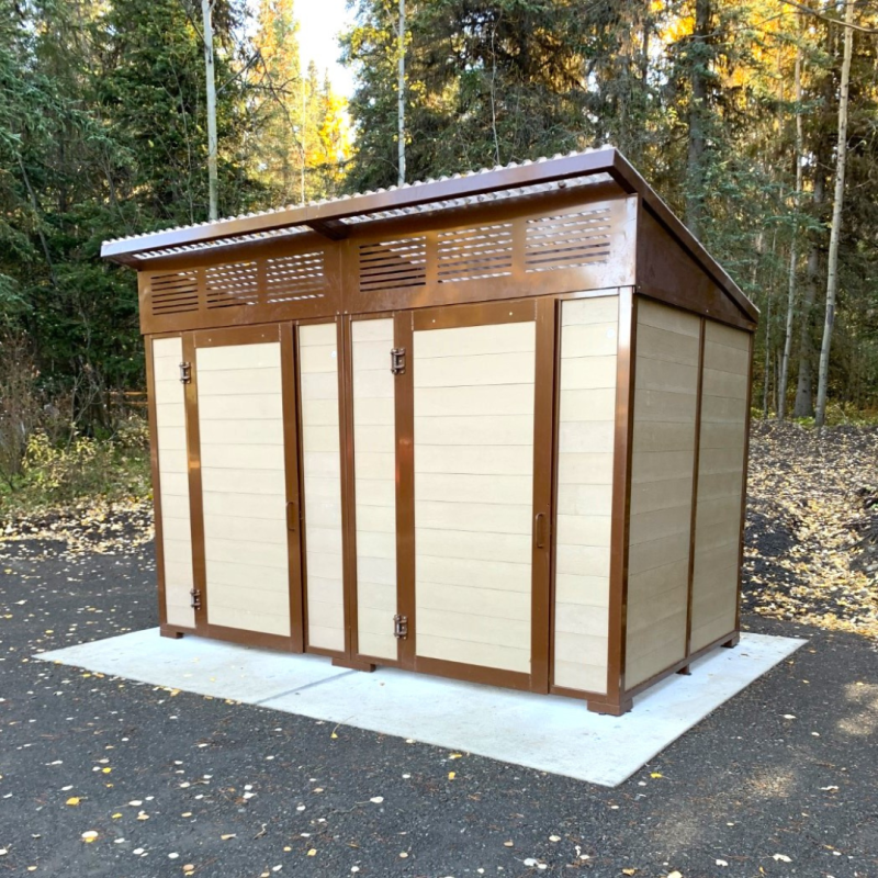 Photo of a new washroom facility with two doors and a slanted roof. 